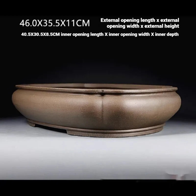 Handmade antique Pukou style papaya-shaped purple clay flower pot on a table.