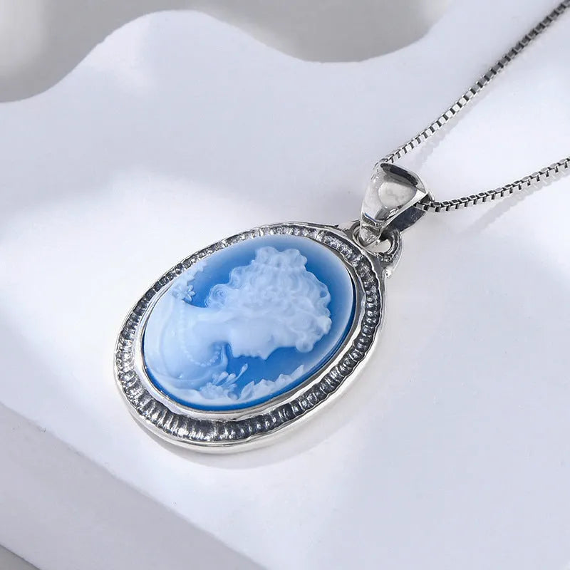 S925 sterling silver pendant with embossed blue and white agate oval portrait on white background