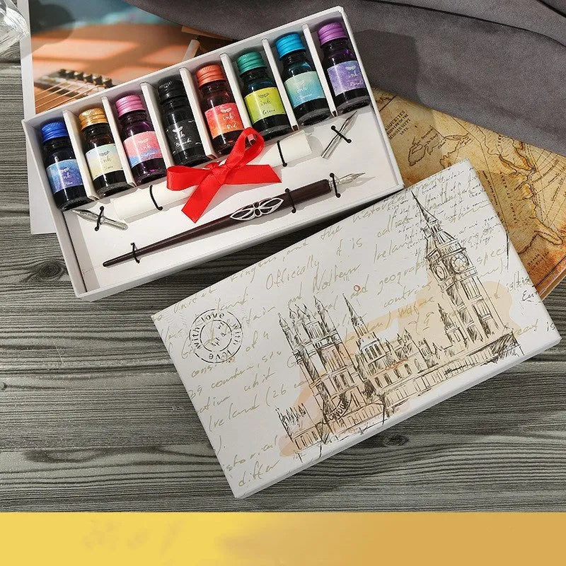 Wooden dip pen set with eight coloured ink bottles, two nibs, and blank paper in a wooden box