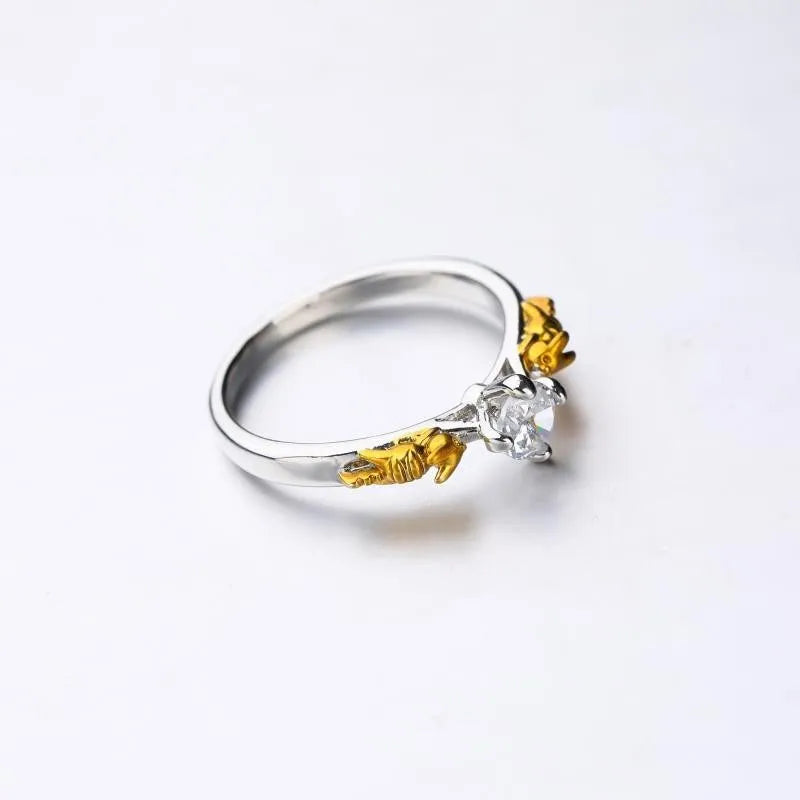 Black gold finished copper ring with a detailed crown motif and crystal settings on a finger.