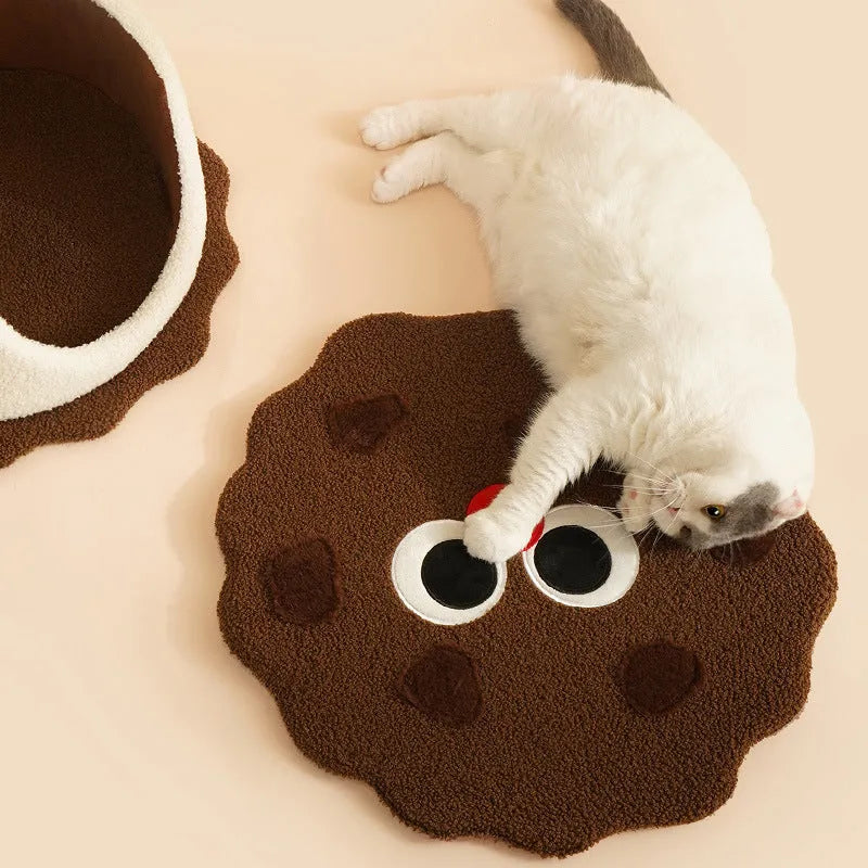 Khaki-coloured closed cat house with a nest shape resembling a sandwich cookie.