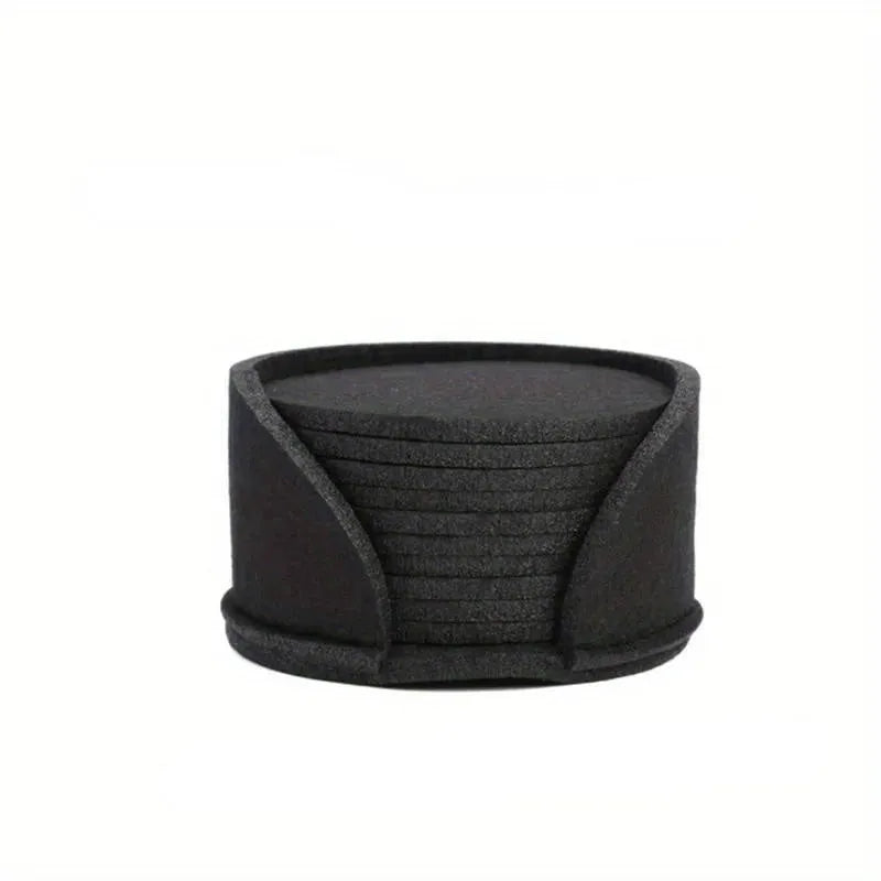10 round felt coasters in black, brown, dark gray, and light gray arranged on a dining table