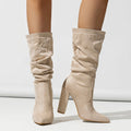 Women's black suede high heel boots with a chunky heel and pointed toe, mid-calf length.