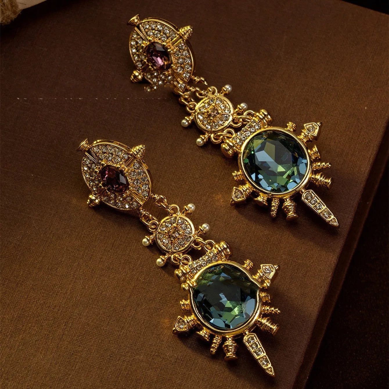 A pair of round geometric stud earrings with a gold finish and retro court style design.