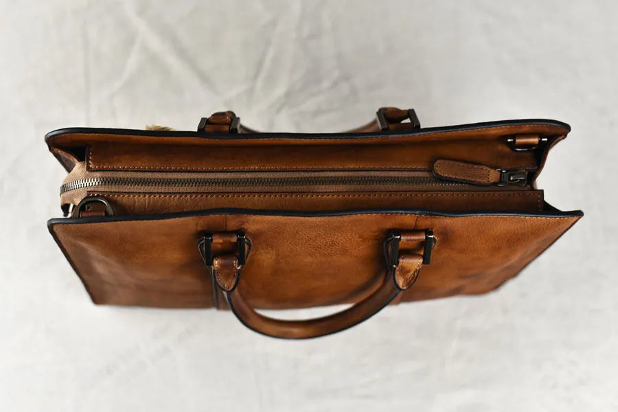 Men's brown leather horizontal business handbag with zipper closure showing retro design