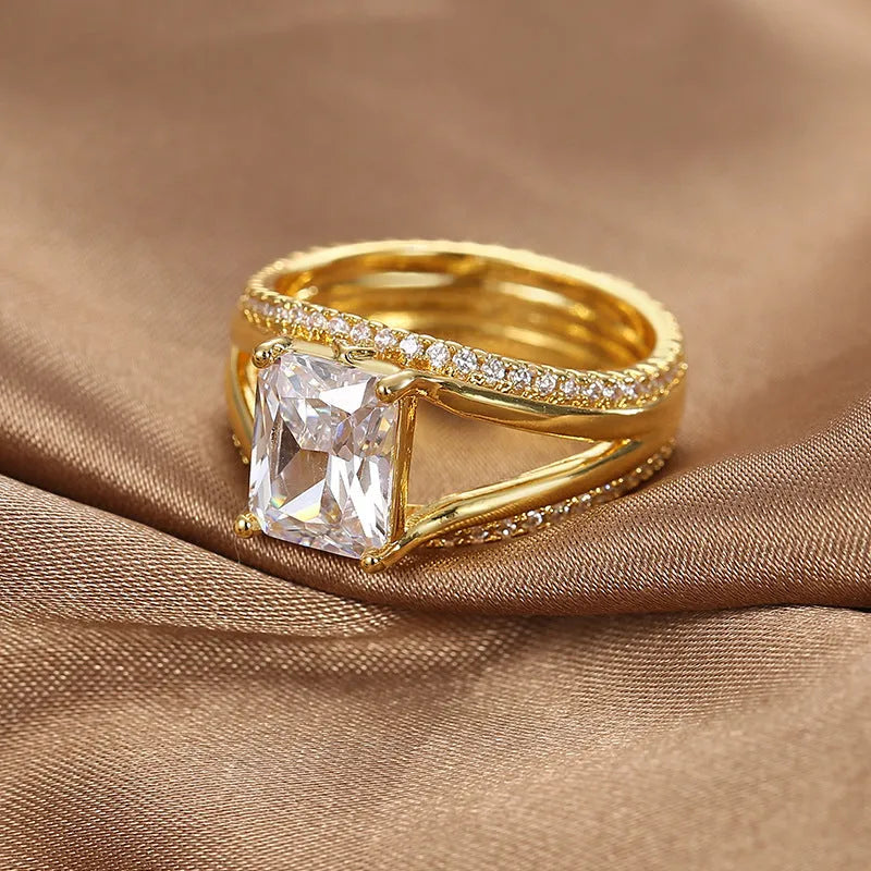 Women's geometric gold ring with square zircon centrepiece showing clean lines and electroplated finish