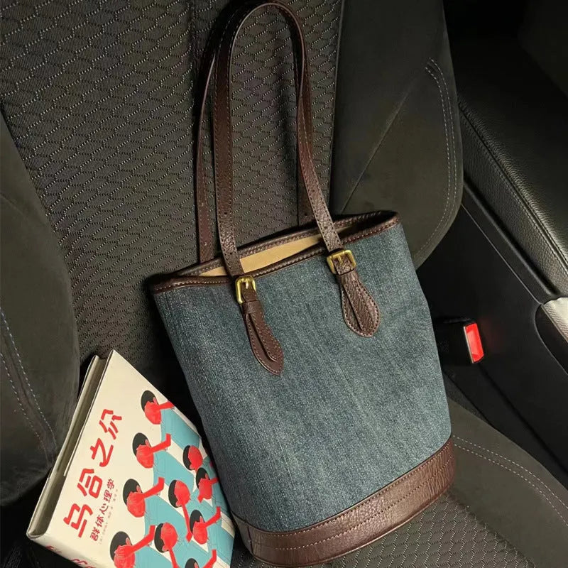 Denim patchwork handbag with retro bucket design showing dimensions and one-shoulder strap