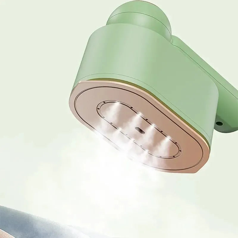 Green portable 1200W garment steamer with foldable handle on white background