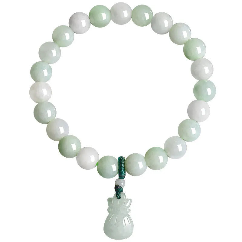 Close-up of an 8mm floral carved jade bracelet on a wrist.