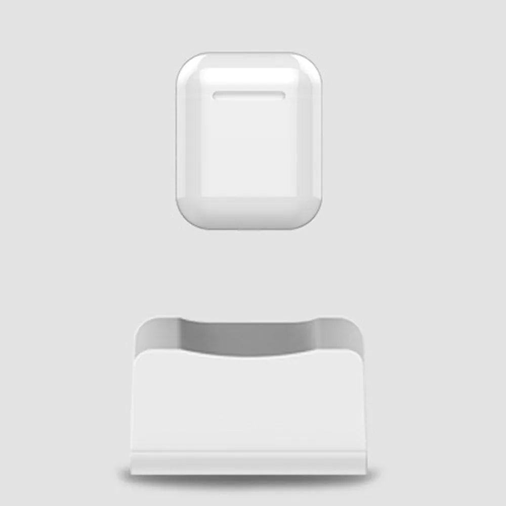 White plastic headphone charging base for wireless earbuds on desk