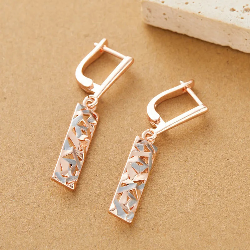 Rectangular two-tone hollow stud earrings with electroplated finish and geometric design