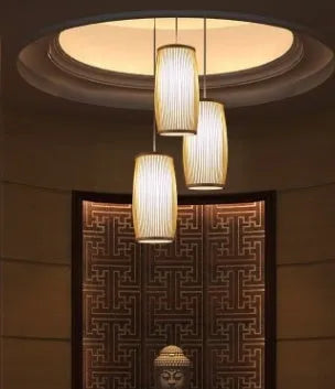 Small bamboo plaited wall light with natural finish, shown mounted on a wall.