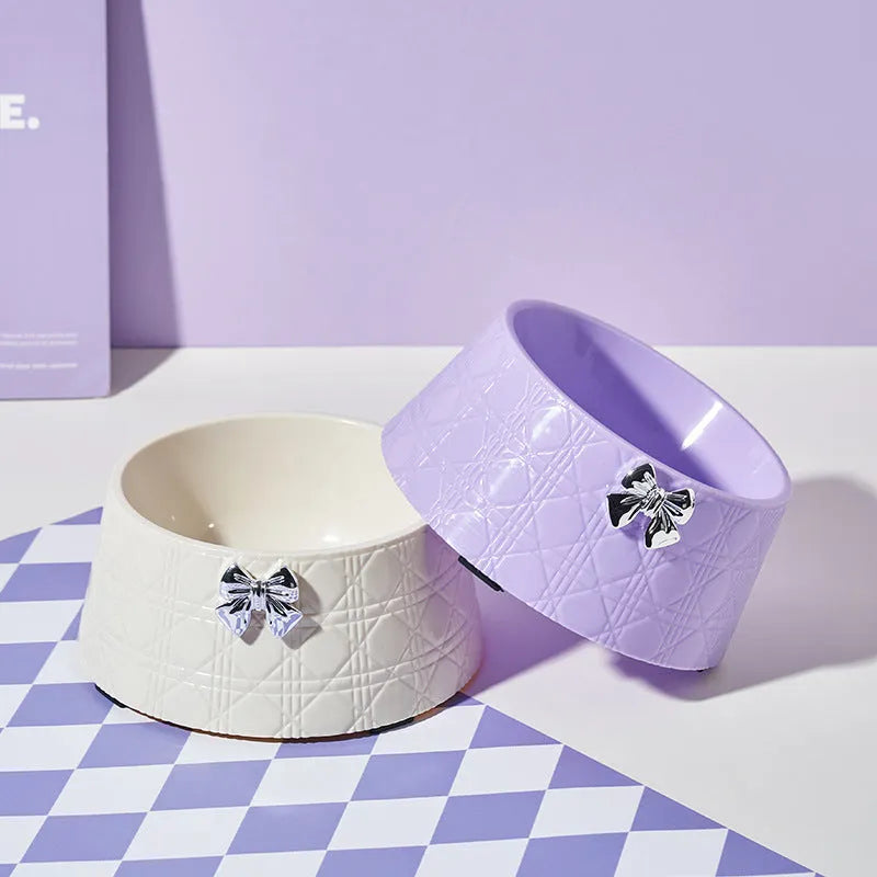 Ceramic pet bowl with diamond pattern and a bowknot decoration in pink, silver, black, purple, or white
