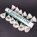 Twelve white training badminton shuttlecocks with feather skirts and cork bases arranged in a pack