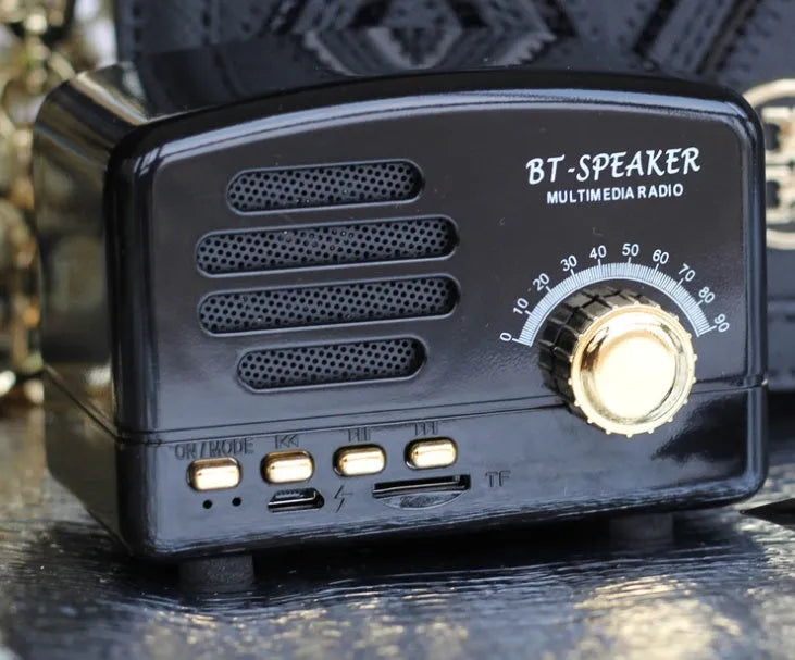 Vintage-style Bluetooth speaker with wood grain finish, showing compact size and front speaker grill.