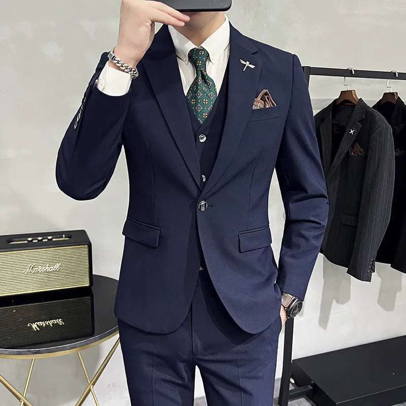 Three-piece men's acetate fibre blend business suit set in light gray with jacket, trousers, and vest.