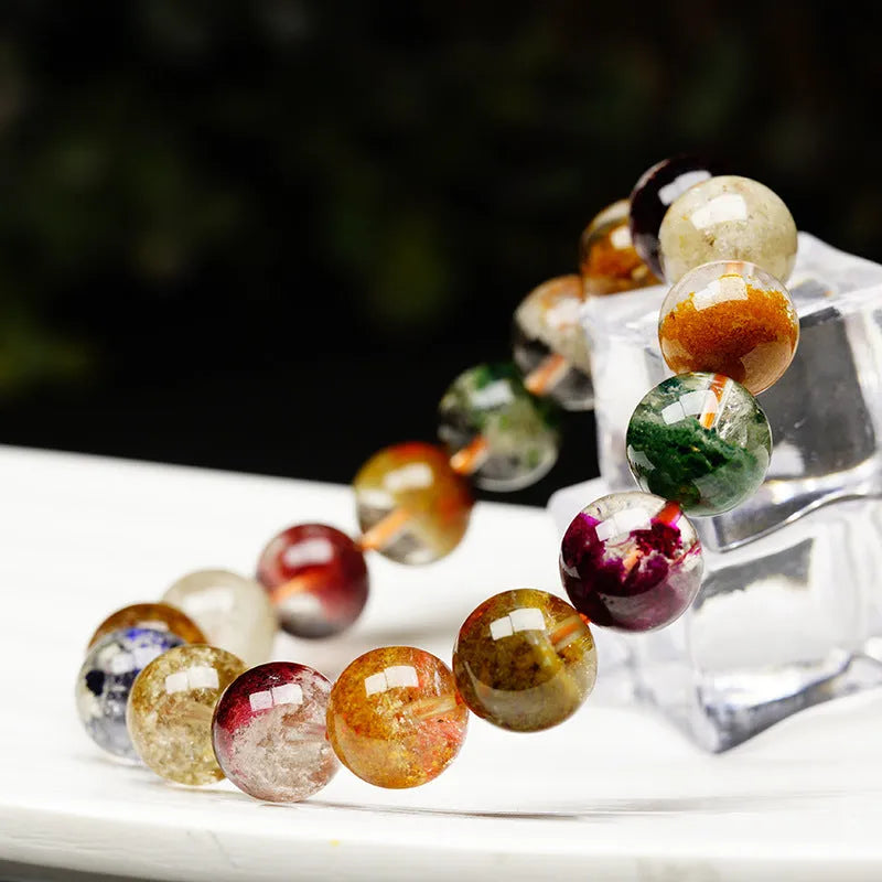 Crystal bracelet with 10mm beads showing a colourful natural four seasons ghost cornucopia ethnic design.