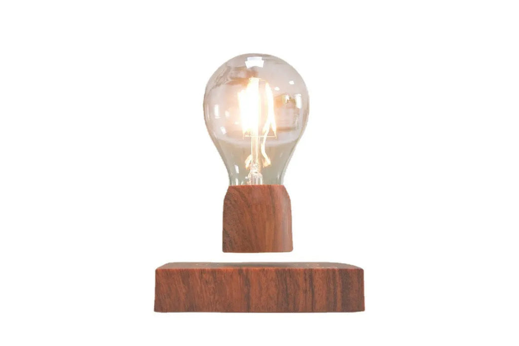 Magnetic levitation floating light bulb hovering above an imitation wood base.