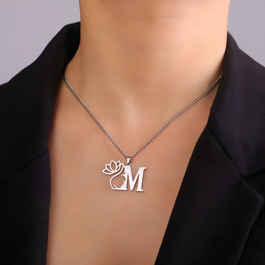 Stainless steel letter necklace with cross chain and single pendant in gold or silver finish.