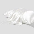 Dark grey silk pillowcase with envelope closure shown folded to display fabric texture