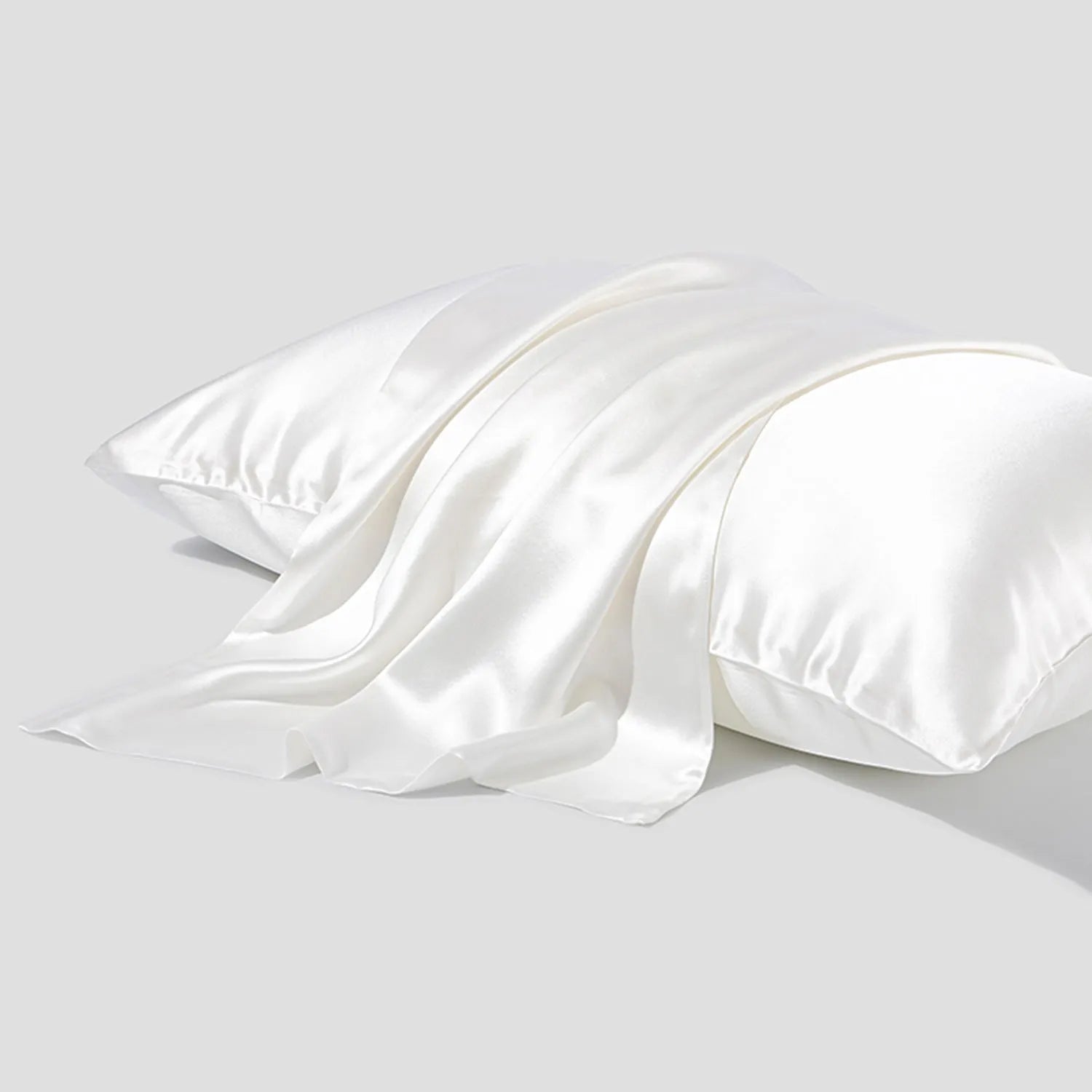 Dark grey silk pillowcase with envelope closure shown folded to display fabric texture