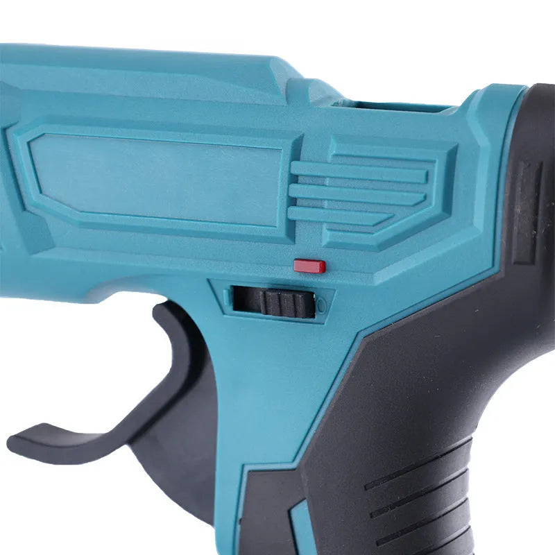 Rechargeable hot melt glue gun with lithium batteries and glue sticks on work surface