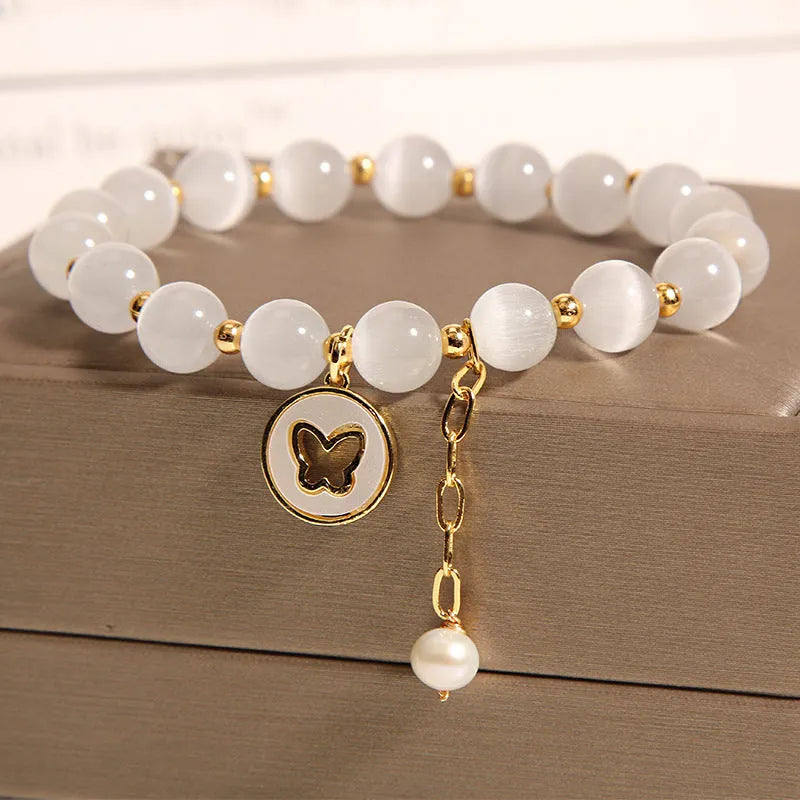 Handmade white cat's eye crystal bracelet with geometric Korean-style design.