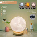 Rotating moon night lamp on a wooden base showing three colour light modes.