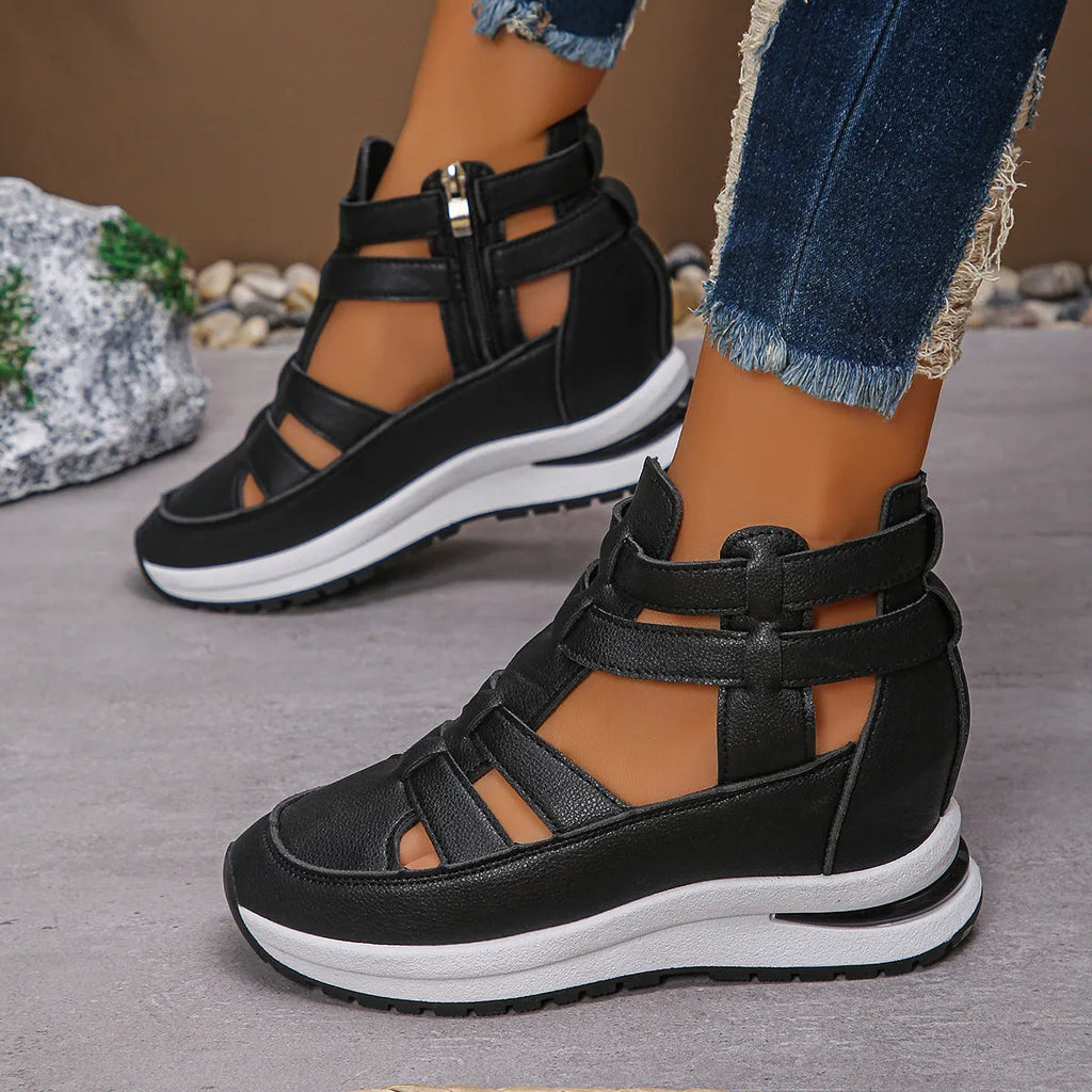 Black women's platform sandals with closed toe, hollow-out design and Velcro strap.