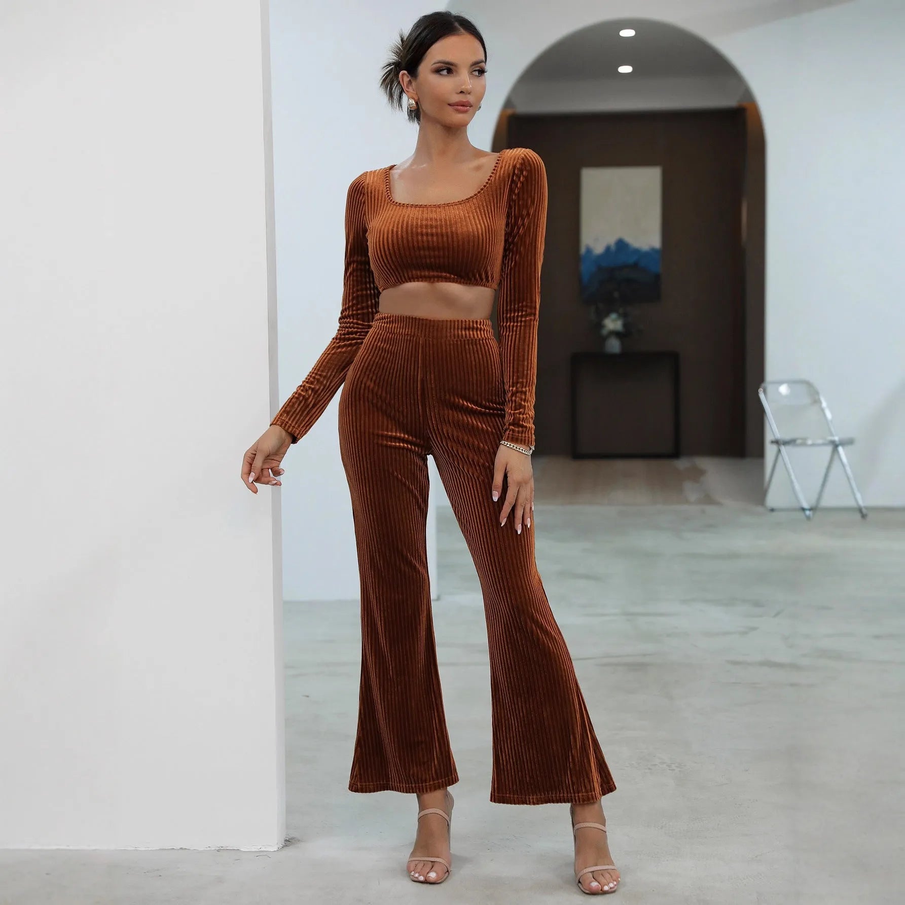 Caramel coloured long sleeve sweater and trousers co-ord set on a hanger