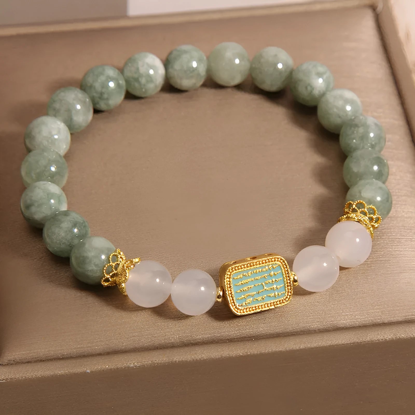 Women's oil green emerald crystal bracelet with five natural gemstones on a wrist.