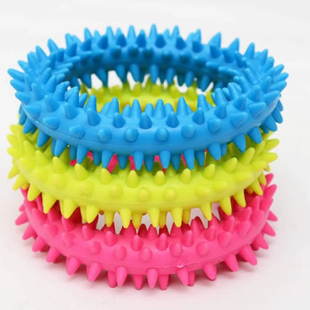 Blue TPR spiky ring dog chew toy for dental cleaning and bite training on a white background.