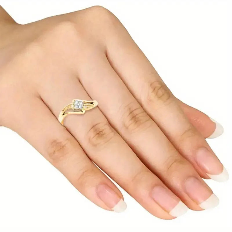 Yellow gold women's geometric diamond ring with a small inlaid zircon stone, shown on a copper band.