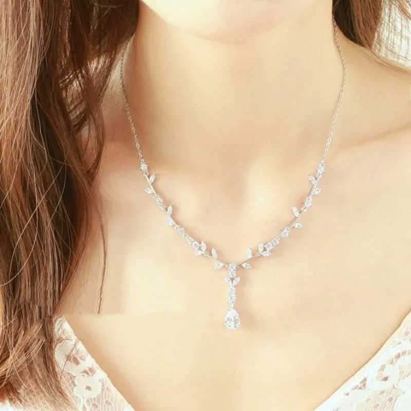 Simple bridal silver alloy love pattern necklace and earrings suite on display, handmade ornament set with ear clip option