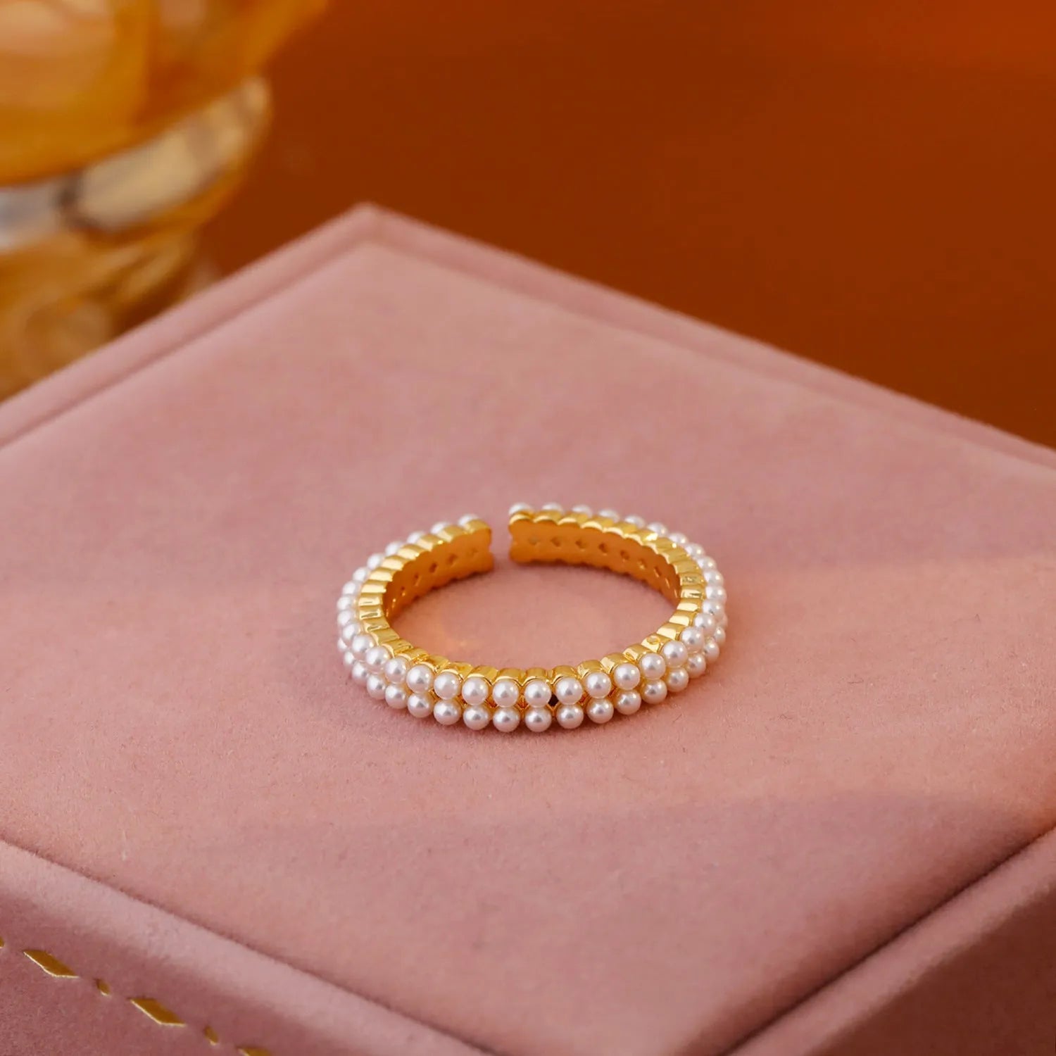 Gold electroplated open mouth pearl ring with geometry design on a copper base.