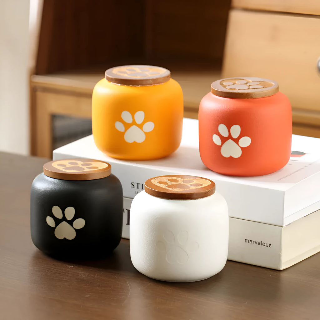 Ceramic pet funeral urn with foot print design in orange colour