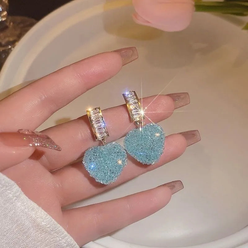 Peach heart-shaped stud earrings with candy gemstone accents in pink and blue colour variations