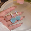 Peach heart-shaped stud earrings with candy gemstone accents in pink and blue colour variations