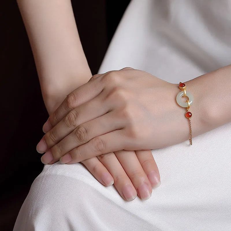 Gold-coloured women's bracelet made of S925 sterling silver with a natural Hetian jade peace buckle charm.