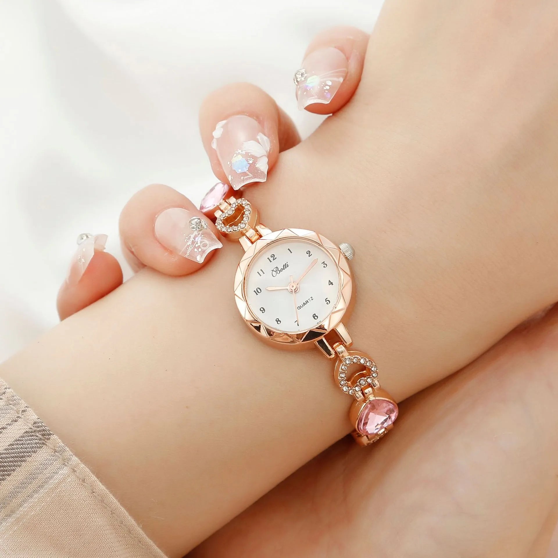 Women's quartz bracelet watch set with earrings necklace ring in pink finish on display