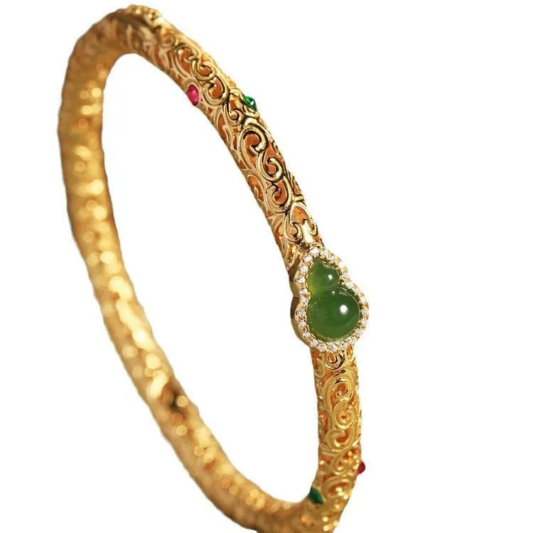 Retro-style open copper bracelet with a detailed gourd charm on a wrist.