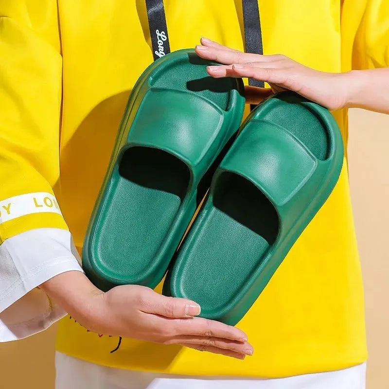 Pair of thick-soled EVA flip-flop slippers in a chosen colour on a plain background.