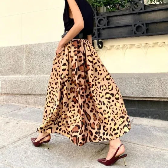Brown leopard print women's long A-line skirt with a full hem on a hanger