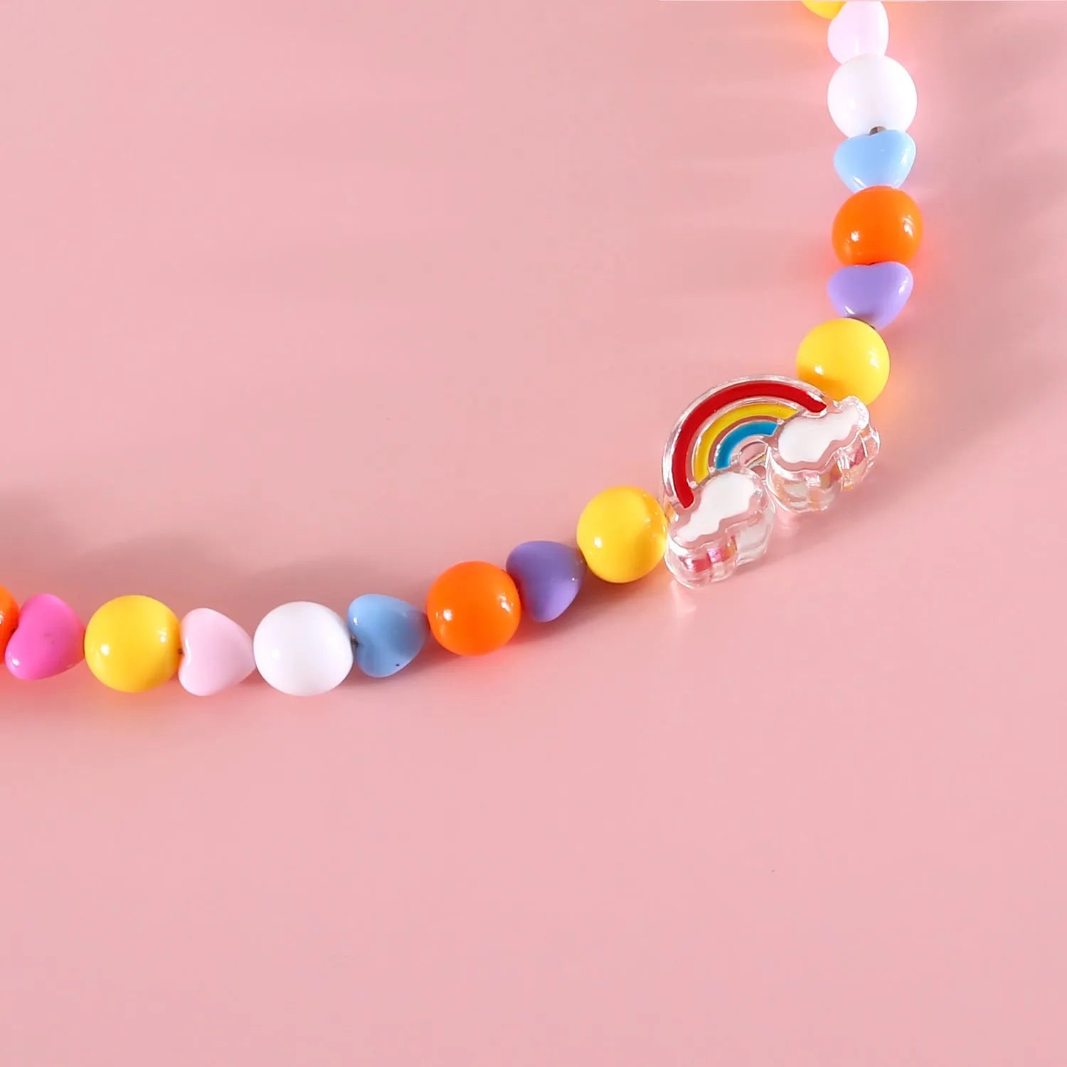 Colourful plastic pearl necklace for small pets on a white background, showing peach, rainbow, and small flower bead design options.