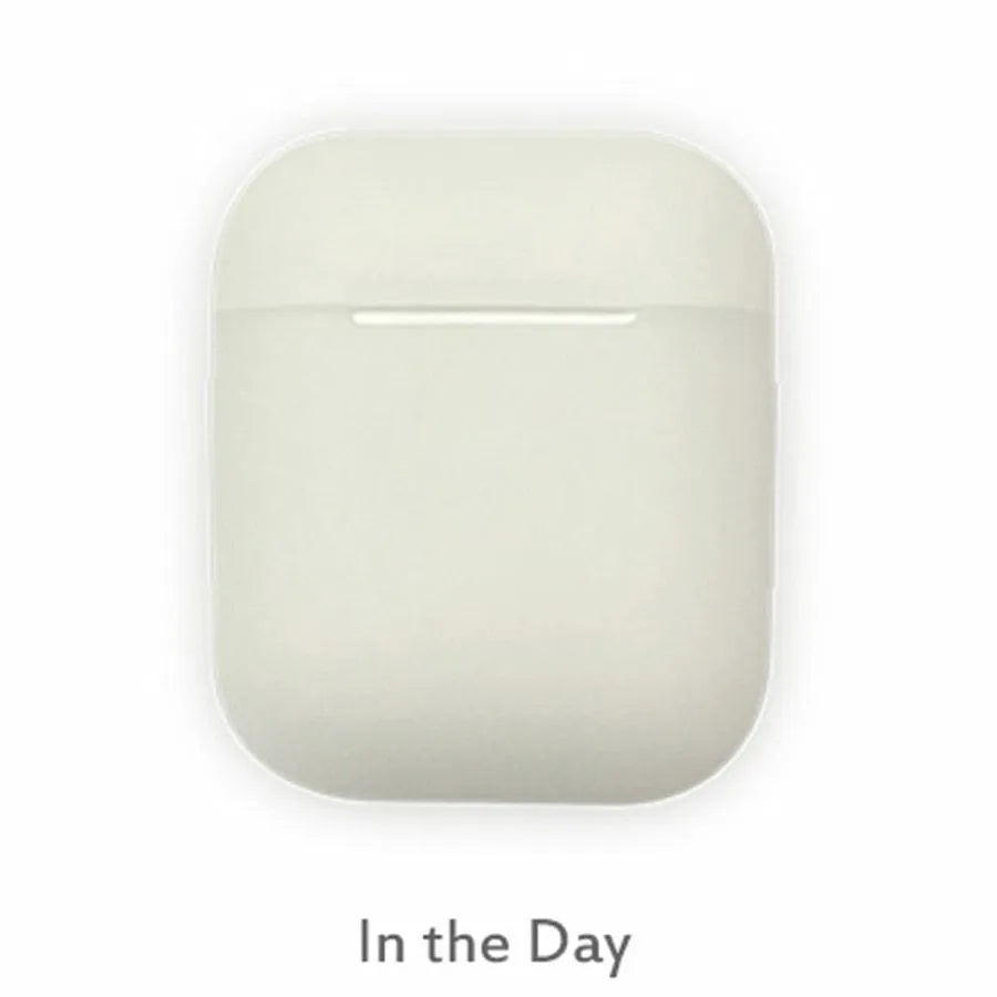 Glow-in-the-dark silicone flip cover case for Apple AirPods charging case on a dark background