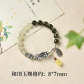 Retro women's silver coin bracelet with a natural Hetian jade stone.