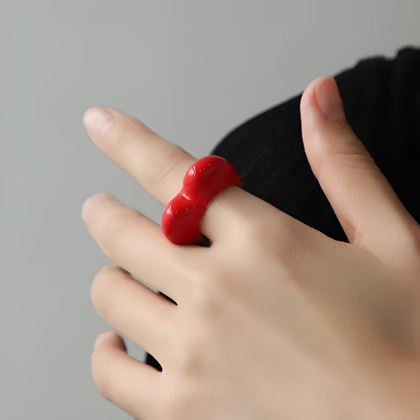 Colourful three-dimensional heart-shaped enamel ring made from zinc alloy, shown in red.
