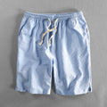 Men's striped casual shorts in cotton, shown in a loose straight-leg fit on a mid-waist.