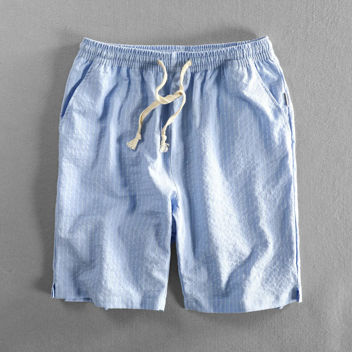 Men's striped casual shorts in cotton, shown in a loose straight-leg fit on a mid-waist.