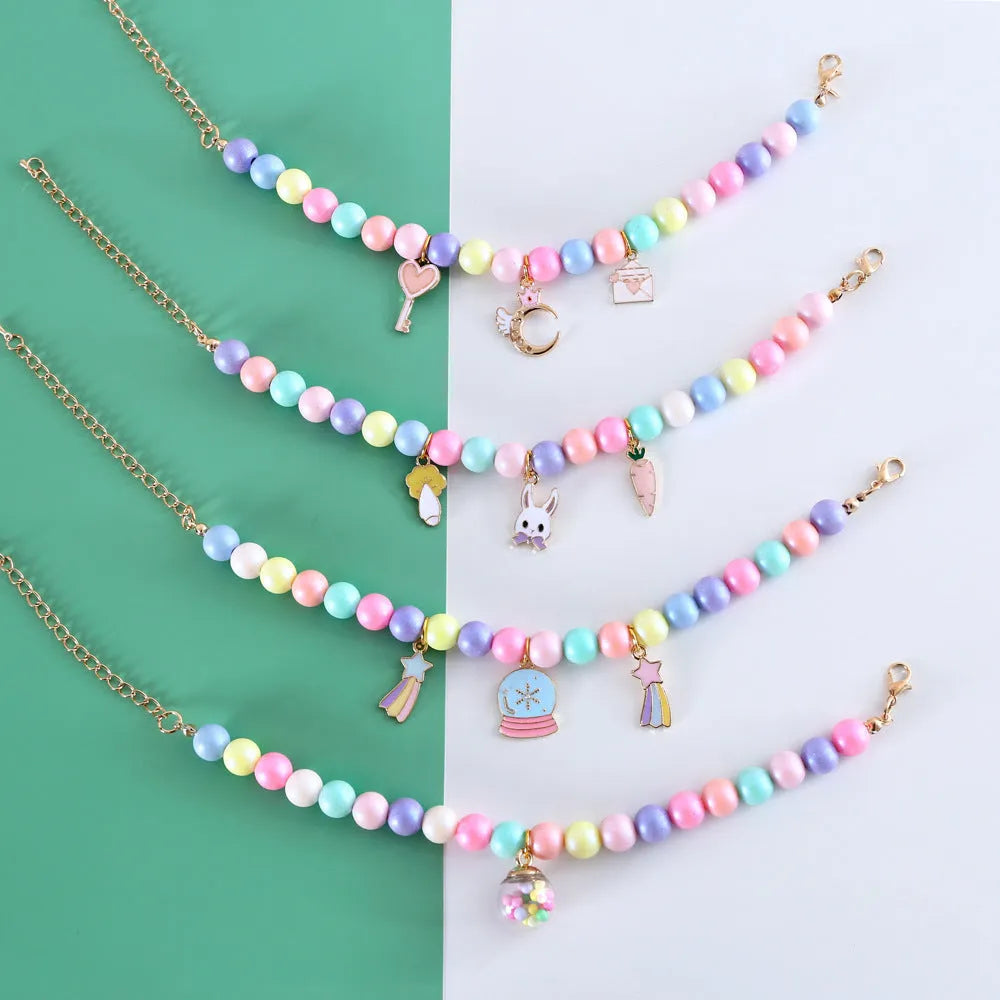 Colourful macaron charm pet collar and bracelet set for rabbits, cats, and dogs in three sizes.